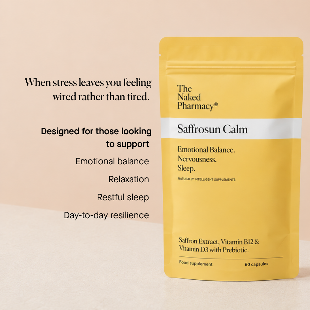 A stand-up pouch of The Naked Pharmacy Saffrosun Calm supplement in a soft yellow color, displayed on a light beige surface with promotional text on the left.